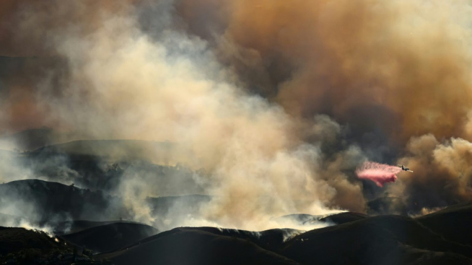 Air tankers fight Los Angeles fires from frantic skies